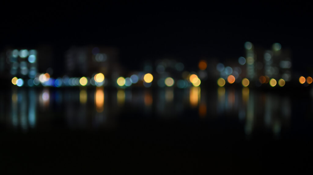 colorful bokeh of city skyline from the river in night time